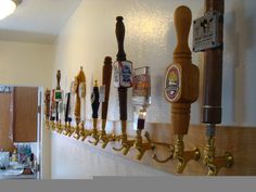 a row of beer taps mounted to the side of a wall