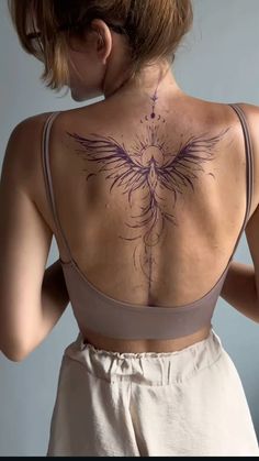 a woman with a tattoo on her back