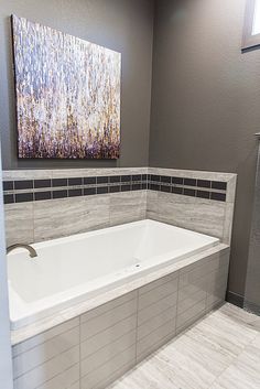 a white bath tub sitting inside of a bathroom next to a walk - in shower