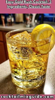 a glass filled with ice and lemon on top of a counter