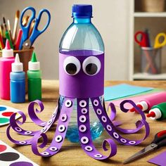 an octopus made out of water bottle sitting on top of a table next to craft supplies