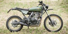 a dirt bike parked on top of a grass covered field