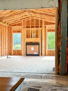 the inside of a house being built with wood framing on the walls and flooring