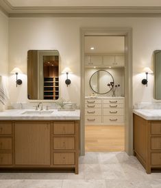 a large bathroom with two sinks and mirrors