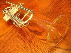 a trumpet sitting on top of a wooden table