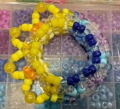 several different colored beads in a plastic container