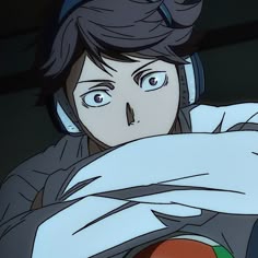 an anime character with headphones on holding a red object in her hand and looking at the camera