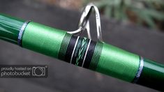 a close up view of a green bike handlebar with silver rings on it's end