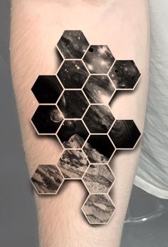 a man's arm with an abstract tattoo design on it, and hexagonal shapes