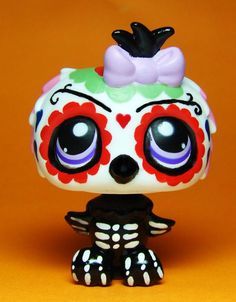 a close up of a small figurine on a yellow background