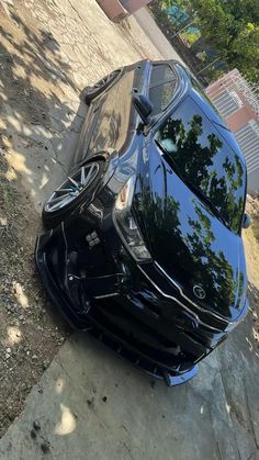 the front end of a car that has been badly dented and is sitting on the sidewalk