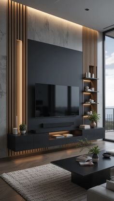 a living room with a large television on top of a wooden entertainment center next to a window