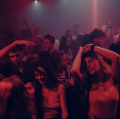 a group of people dancing in a club