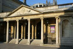 an old building with columns in front of it