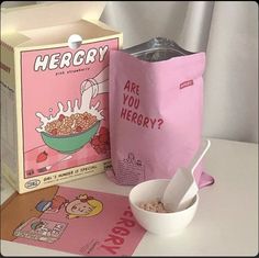 cereal in a bag next to a box and spoon on a table with other items