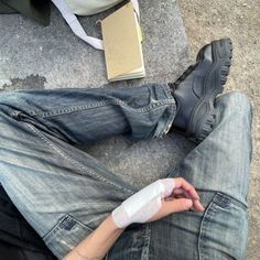a person with an injured arm sitting on the ground