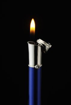 a lighter is lit on a black background with no one around it to see the light