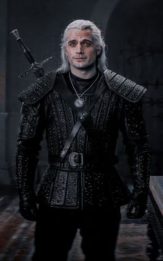 a man with white hair wearing black leather armor and holding two swords in his hand