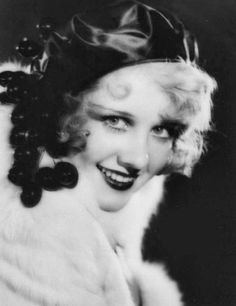 an old black and white photo of a woman wearing a fur coat with large earrings