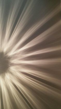 the sun is shining brightly in the sky with long lines going through it and creating a circular shape