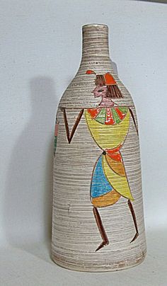 a ceramic vase with an image of a woman on it