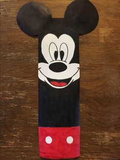 a mickey mouse towel on top of a wooden table