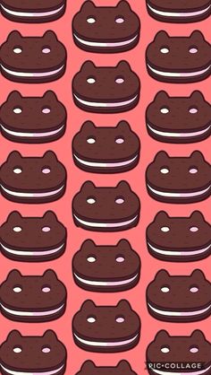 a bunch of cookies that are in the shape of cats on a pink background with white dots