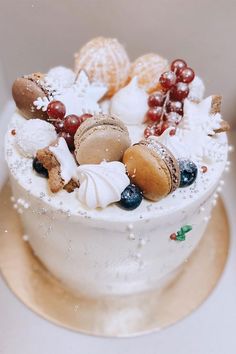 a white cake topped with lots of different types of cookies