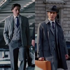 two men in suits and hats are walking down the street with suitcases on wheels