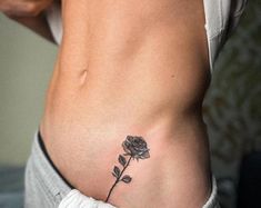 a woman with a rose tattoo on her stomach