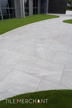 an empty concrete walkway in front of a building