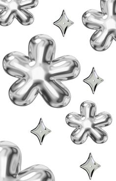 an image of some shiny metal objects in the shape of flowers and stars on a white background