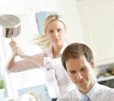 a man and woman are in the kitchen with one holding a pan over his head