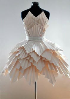 a dress made out of folded paper on a mannequin