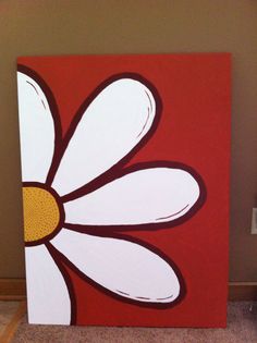a red and white flower painted on a canvas