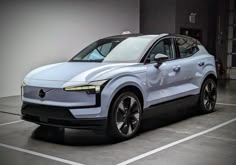 an electric car is parked in a parking lot next to a wall with white walls