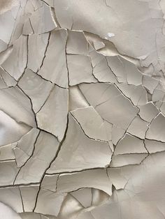 an abstract white background with cracked paint