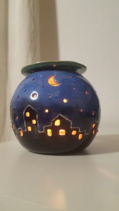 a blue vase sitting on top of a white table