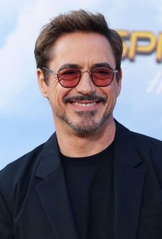 the actor is smiling and wearing sunglasses