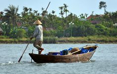a man in a boat with two oars on the water