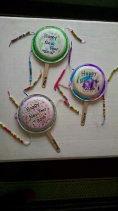 three lollipops with happy new year written on them