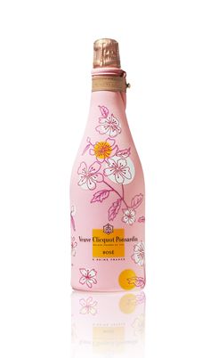 a pink bottle with white flowers on it
