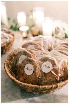 some cookies are wrapped in plastic and sitting on a table next to candlelight candles