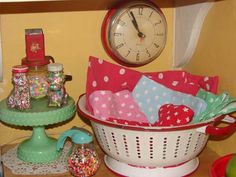 there is a clock on the wall next to a basket and other items in front of it