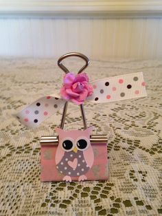 an owl with a pink flower on it's head is attached to a key chain