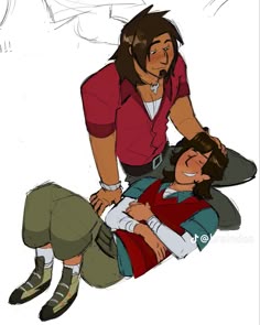 two people are sitting on the ground and one is holding another person's head