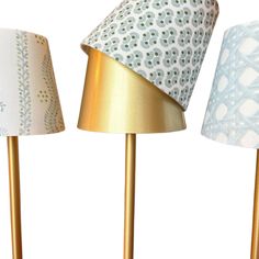 three lamps with different shades on them and one is gold, the other has blue