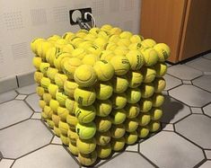 a bunch of tennis balls stacked on top of each other
