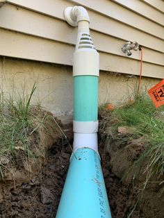 a blue and white pipe sticking out of the ground