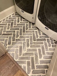 two microwave ovens sitting next to each other on a floor in a room with wood floors